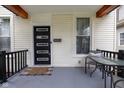 Inviting front porch with a modern front door, outdoor seating area, and neutral decor at 3035 Guilford Ave, Indianapolis, IN 46205