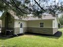 Side and rear view of home featuring updated siding and rear entrance at 321 S 23Rd St, Elwood, IN 46036