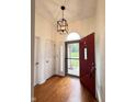 Inviting foyer featuring hardwood floors and a stylish light fixture at 3327 Boxwood Dr, Indianapolis, IN 46227