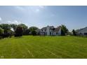 Expansive backyard featuring a lush lawn, mature trees, and a charming playset at 3610 Homestead Pl, Plainfield, IN 46168