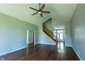 Bright living room featuring hardwood floors, a vaulted ceiling, and staircase to the second floor at 3610 Homestead Pl, Plainfield, IN 46168