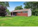 The backyard with a covered porch area and a partial fence at 3921 S Lasalle St, Indianapolis, IN 46237