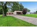 A cozy home with a well-kept lawn and a two-car garage, perfect for a Gathering at 3921 S Lasalle St, Indianapolis, IN 46237