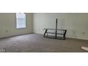 Spacious carpeted room with a large window and TV stand at 403 Bagley Ln, Indianapolis, IN 46231