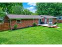 Spacious backyard featuring a lush lawn and a wooden deck with outdoor seating at 4132 Tincher Rd, Indianapolis, IN 46221