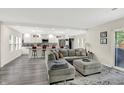 A cozy living room with a gray sectional sofa and views into the modern kitchen at 4132 Tincher Rd, Indianapolis, IN 46221