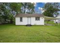 Charming home with a well-maintained lawn, lush trees, and covered parking at 523 Patterson Rd, Columbus, IN 47203