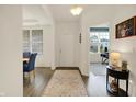 Inviting entryway featuring wood floors, neutral walls, a classic rug, and a view into the office at 5306 Lavender Dr, Plainfield, IN 46168