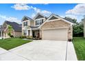 Charming two-story home with a two car garage, stone accents, neutral siding, and inviting curb appeal at 5306 Lavender Dr, Plainfield, IN 46168