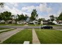 Street view of a quiet residential neighborhood with well-maintained homes and mature trees at 5430 E 17Th St, Indianapolis, IN 46218