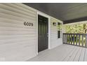 Covered front porch showcasing home number and neutral color scheme at 6029 English Ave, Indianapolis, IN 46219