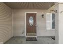 Close up of the front door, with an oval glass insert and decorative window and front porch at 6214 Weller Cir, Indianapolis, IN 46268