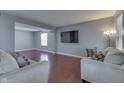 Spacious living room with hardwood floors, a television and access to other rooms at 6214 Weller Cir, Indianapolis, IN 46268