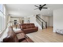 Open concept living room with hardwood floors leading to the kitchen and stairway at 633 Cowley Dr, Westfield, IN 46074