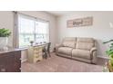 Cozy living room featuring a comfortable sofa, desk near window and neutral carpet flooring at 6737 Trey Dr, Camby, IN 46113