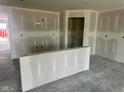 Spacious and bright open-concept area featuring drywall walls and concrete floors at 6812 Rawlings Ln, Indianapolis, IN 46221