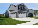 Beautiful two-story home with a three-car garage and well-maintained landscaping at 7153 Sultans Run Ln, Whitestown, IN 46075