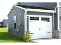 Detached two-car garage featuring a white garage door and gray siding at 7153 Sultans Run Ln, Whitestown, IN 46075