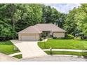 An aerial view displays this single-story home with mature trees and a well maintained lawn at 7175 Scarlet Oak Dr, Noblesville, IN 46062