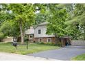 The home has a large driveway and a side porch at 7629 Candlewood Ln, Indianapolis, IN 46250