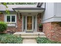 The beautiful front porch has a decorative glass door and a window box at 7629 Candlewood Ln, Indianapolis, IN 46250
