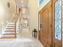 Inviting foyer with tile flooring, wooden staircase and a decorative glass door at 817 Hickory Way, Noblesville, IN 46062