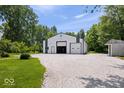 Large white and green barn with multiple garage doors and a gravel driveway at 881 W 1050 N, Fortville, IN 46040