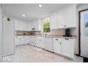Bright kitchen with white cabinets, appliances, and a door to the outside at 881 W 1050 N, Fortville, IN 46040