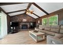 Cozy living room with wood paneling, brick fireplace, and comfortable seating at 881 W 1050 N, Fortville, IN 46040