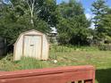 View of shed and backyard with mature trees at 8849 Summer Walk E Dr, Indianapolis, IN 46227