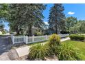 Quaint home with a white picket fence, mature trees, and well-maintained landscaping at 917 W Busby St, Lebanon, IN 46052
