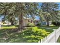 Charming home with mature trees, a well-manicured lawn, and white picket fence at 917 W Busby St, Lebanon, IN 46052