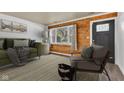 Cozy living room featuring hardwood floors, rustic wood-paneled wall, and bright window views at 917 W Busby St, Lebanon, IN 46052