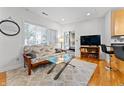 Bright living room with hardwood floors, a comfortable sofa, and great natural light streaming in through the windows at 932 N Broadway St # 4, Indianapolis, IN 46202