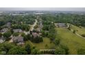 Aerial view of neighborhood featuring a home with outlined property lines and mature trees at 10455 Trewithen Ln, Carmel, IN 46032