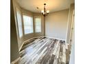 Bright dining room with wood-look floors and large bay windows with neutral paint at 1173 Carlton Ct, Greenwood, IN 46143