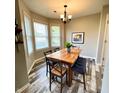 Inviting dining room with wood table, stylish chairs, and natural light from bay windows at 1173 Carlton Ct, Greenwood, IN 46143