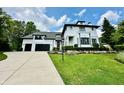 Beautiful front yard with luscious landscaping and two-car garage at 12208 Island Dr, Indianapolis, IN 46256