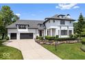 Stately home with manicured front yard, two-car garage, and classic architectural details at 12208 Island Dr, Indianapolis, IN 46256