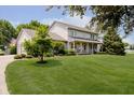 Inviting exterior of home with a covered front porch featuring rocking chairs and a lush green lawn at 12251 E 196Th St, Noblesville, IN 46060
