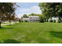 Sprawling front yard with a beautiful two-story home surrounded by mature trees and a long driveway at 12251 E 196Th St, Noblesville, IN 46060