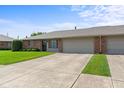 Brick facade with attached garage and well-kept lawn, showcasing a welcoming front exterior at 1309 Wyoming Way, Anderson, IN 46013