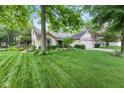 Lovely single-story house with mature trees and inviting walkway at 1482 Waterford Dr, Zionsville, IN 46077