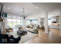 Spacious open-concept living room that showcases an elegant design and flows into the dining and kitchen areas at 15926 Bellows Ave, Fishers, IN 46040