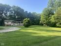 Peaceful home with a large yard, framed by tall trees creating a private, serene setting at 162 W Robertson Rd, Morgantown, IN 46160