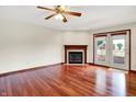 Bright living room showcasing hardwood floors, a classic fireplace, and French doors leading to the backyard at 177 Jacinta Pl, Bargersville, IN 46106
