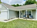 Charming home with inviting covered porch, well-manicured lawn, and tasteful landscaping at 213 Drewood Dr, Trafalgar, IN 46181