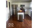 Well-lit kitchen with stainless steel appliances and a butcher block island, perfect for cooking at 2231 Abbey St, Brownsburg, IN 46112