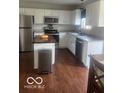 Inviting kitchen featuring stainless steel appliances, white cabinetry, and butcher block island counter at 2231 Abbey St, Brownsburg, IN 46112