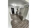 Modern kitchen with stainless steel appliances, gray cabinets, and wood floors, offering functionality at 3201 W 22Nd St, Indianapolis, IN 46222